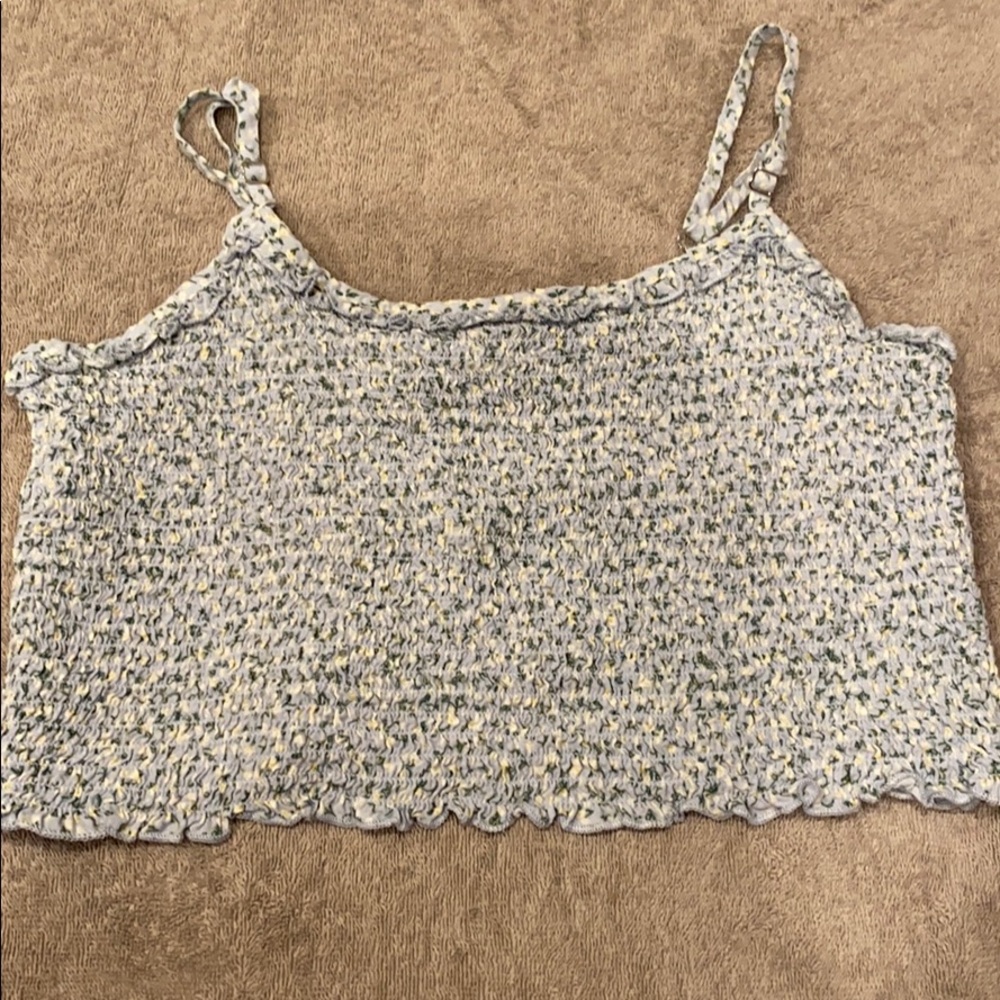 Cropped blue tank with little whit flowers on it.